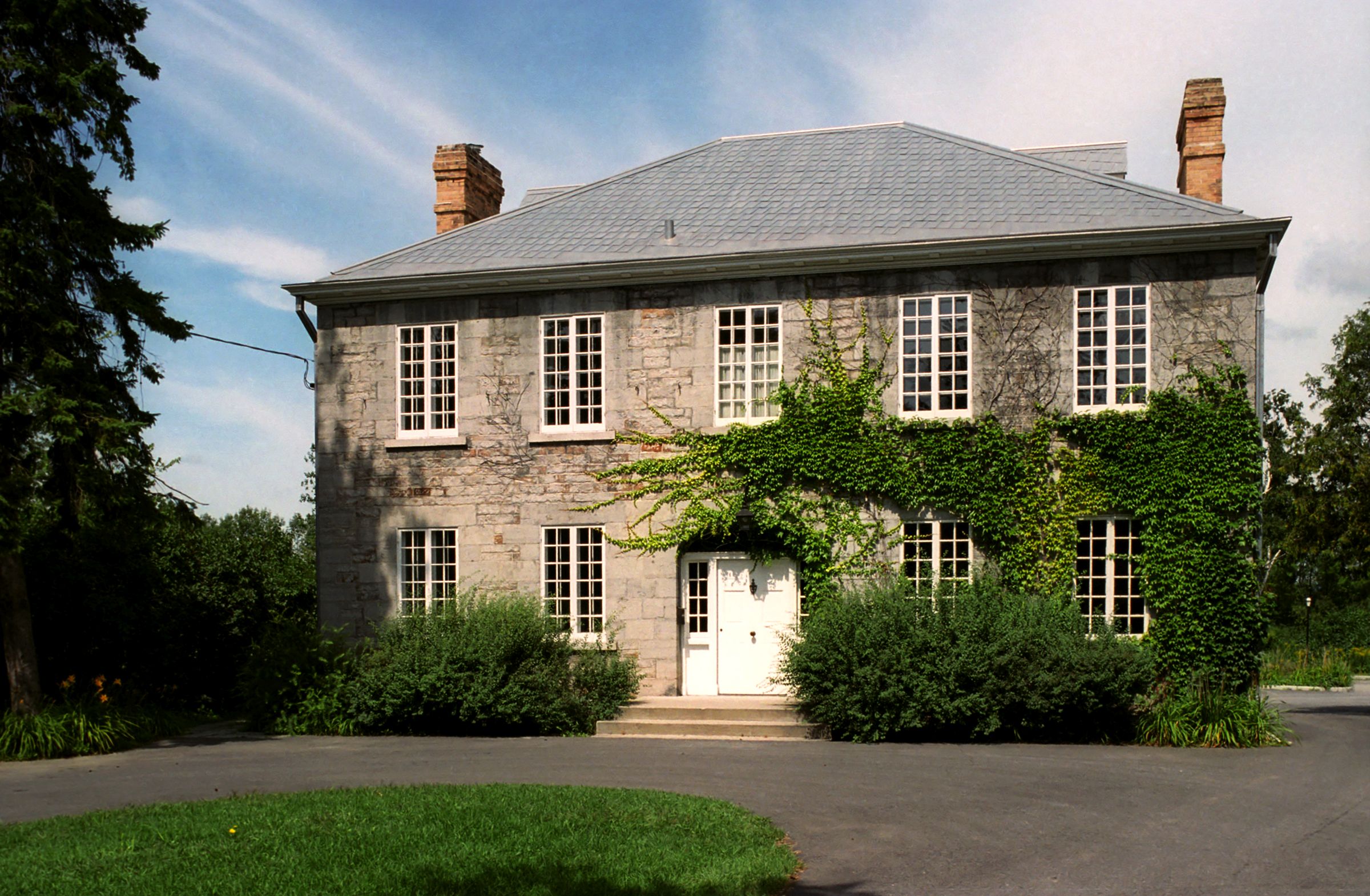 Exterior view of a stone Georgian-style estate built between 1831 and 1833.